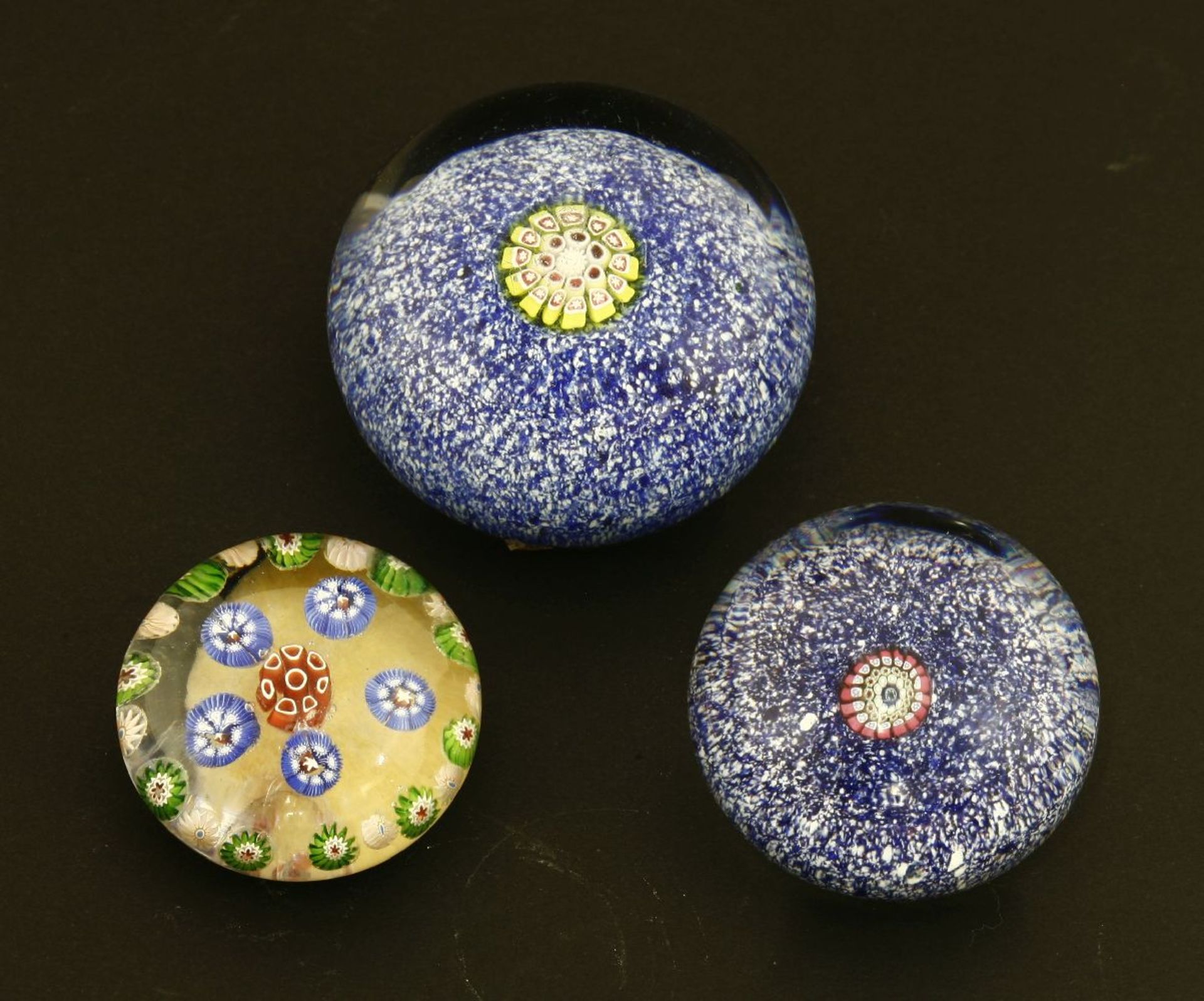 Three St Louis paperweights,two with jasper grounds with central canes,4 and 5cm diameter,one with