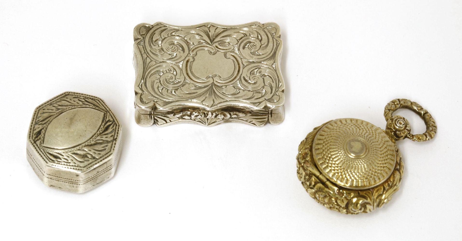 Three silver vinaigrettes,David Pettifer, Birmingham, 1853,of serpentine shape with engraved