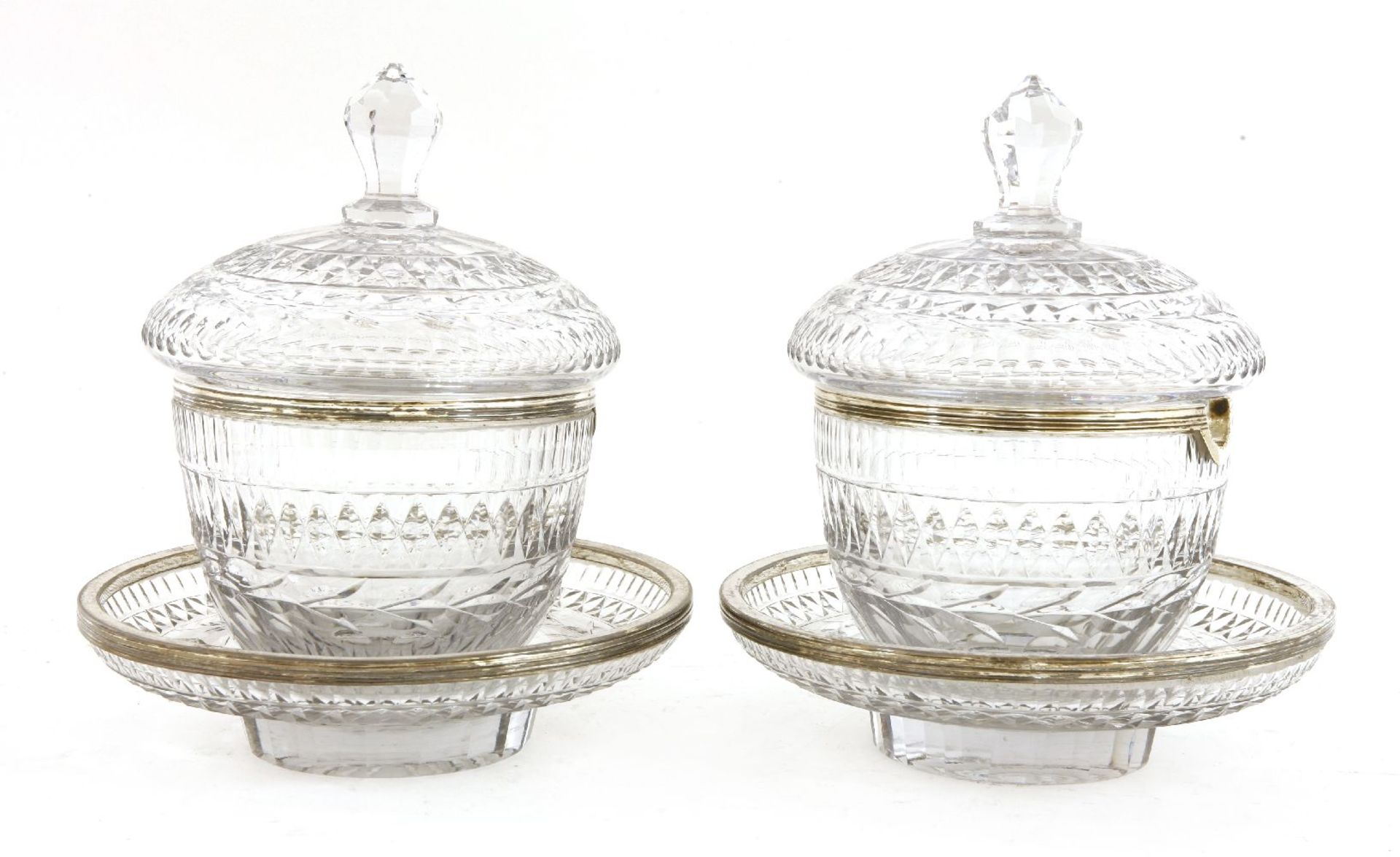 A pair of Georgian Irish berry dishes,cut glass and white metal mounted, each with a domed cover