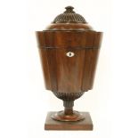 A George III mahogany cutlery box, of shaped tapering circular design, with a rise/fall mechanism,