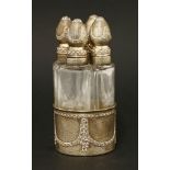 A late 19th/20th century French silver gilt four-bottle perfume set,the wedge-shaped bottles