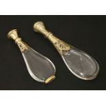 Two clear glass teardrop scent bottles,19th century, with engraved silver gilt and French gold