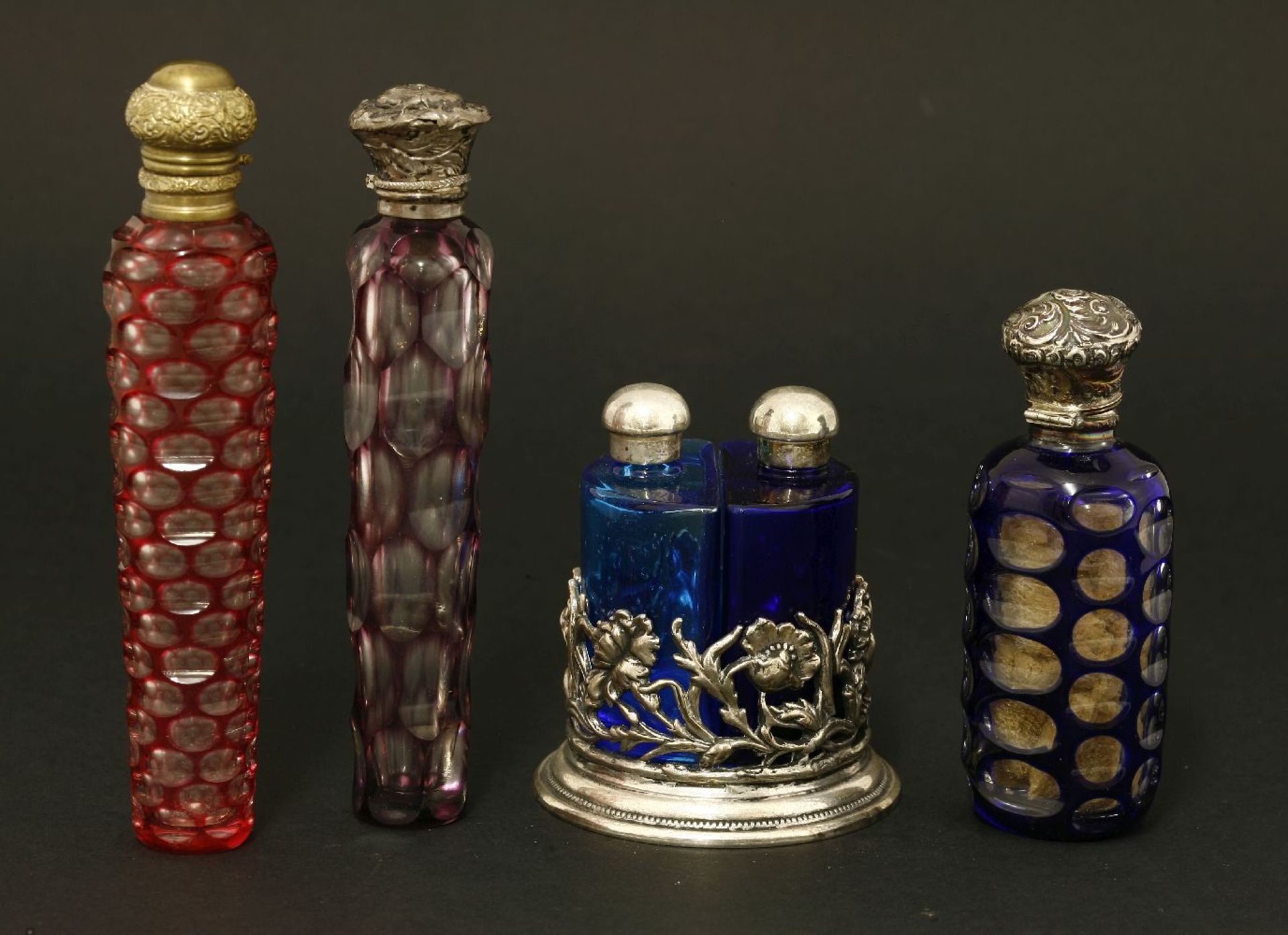 Three bohemian flash-dipped glass scent bottles,largest 13.5cm, anda plated holder containing two