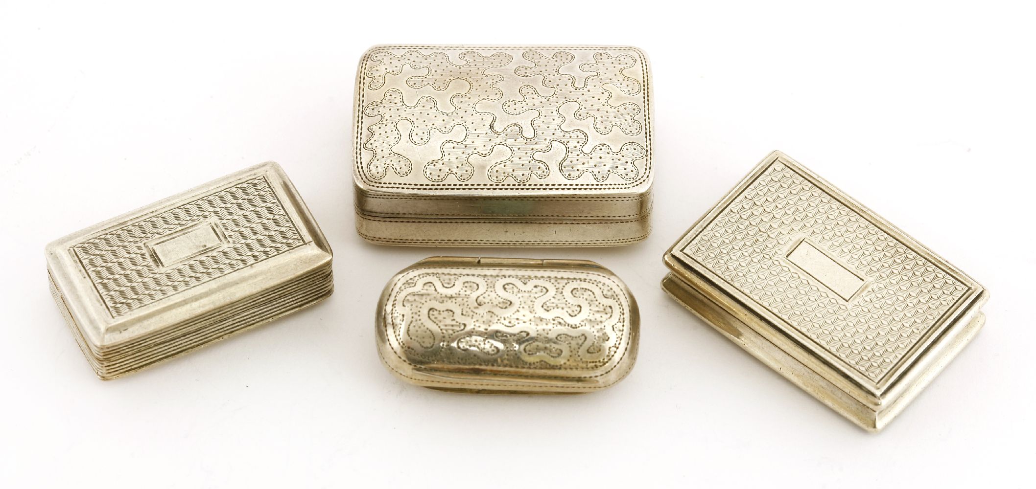 Four silver vinaigrettes,Slapson & Son, Birmingham c.1810,of 'bean' shape with engraved decoration,