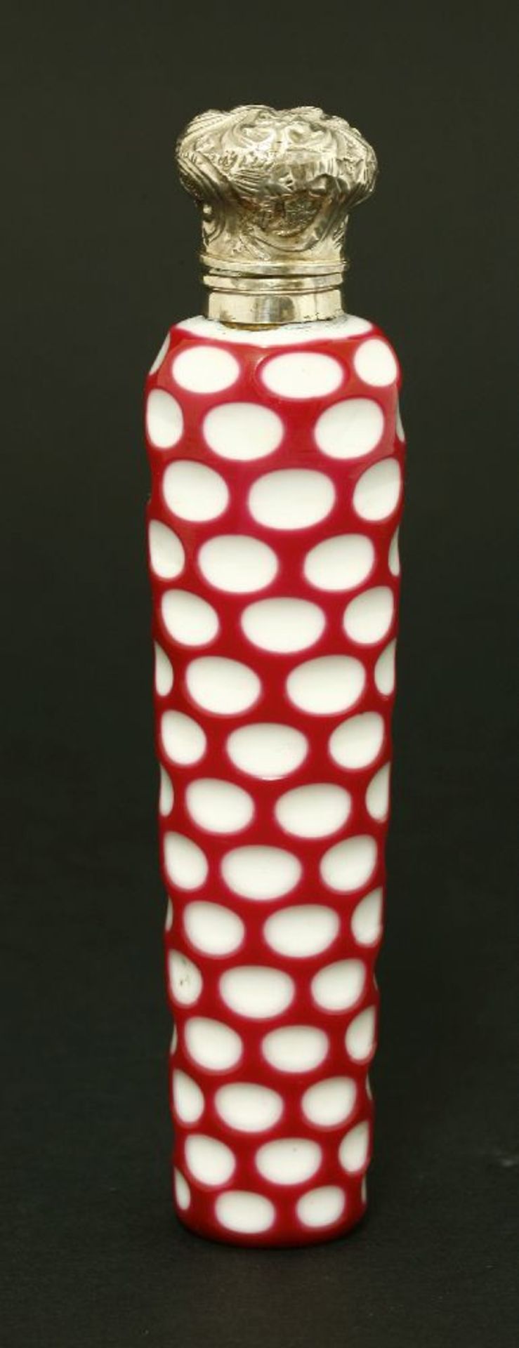 A Bohemian glass scent bottle,overlaid in red and white glass with cut graduated ovals below a