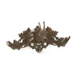 A Black Forest carved linden wood coat hook,late 19th century, with chamois head amongst oak