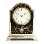 A George V silver mantel clock, Birmingham 1907, the convex enamel dial within a silver inlaid