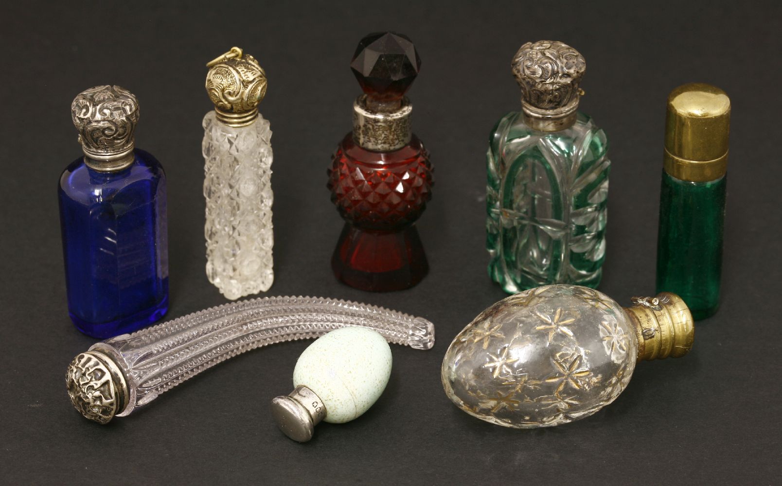 Eight Victorian scent bottles,including:a Sampson Mordan egg with a silver cover,a cut glass horn