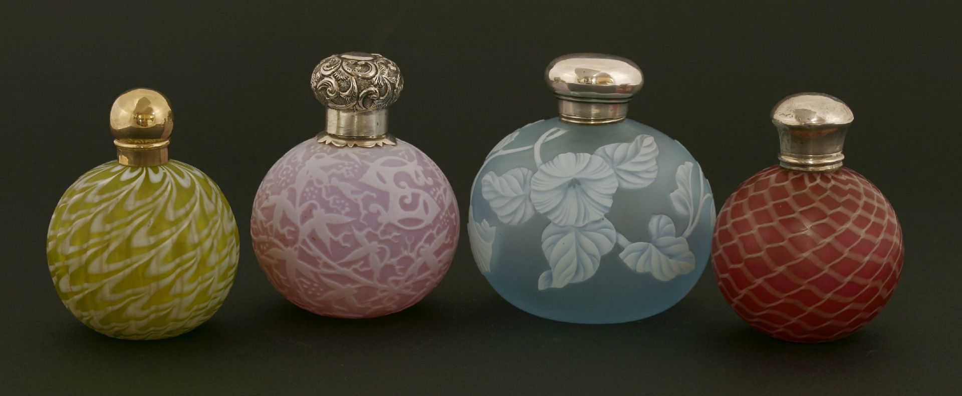 Four coloured glass scent bottles,with overlaid decoration, all of globular shape,one silver,Chester