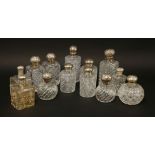 Eight glass cologne bottles,six with silver covers,a pair of Continental examples with sterling