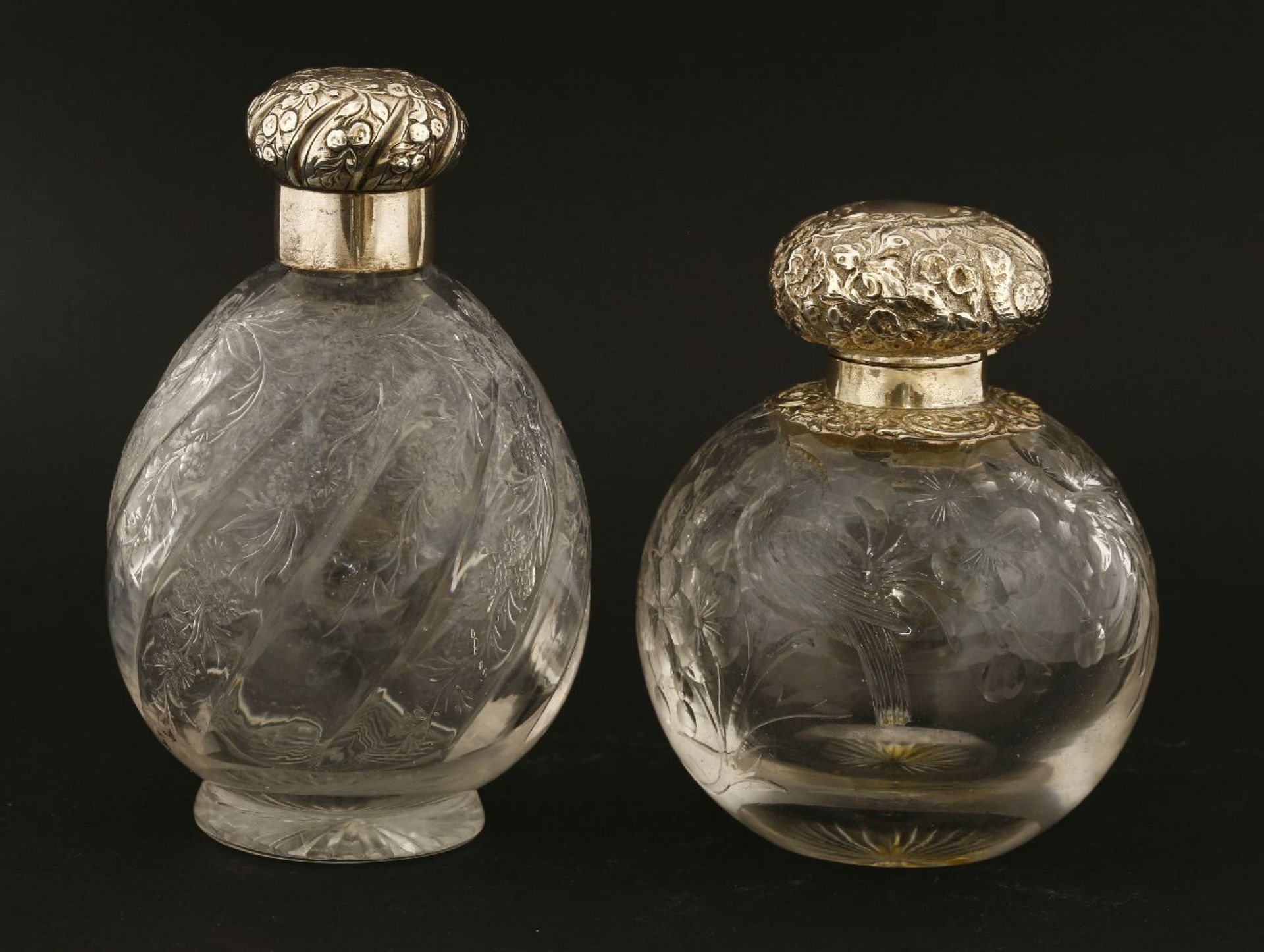 Two glass cologne bottles,with 'rock crystal' style cut decoration,one London 1892,the other with