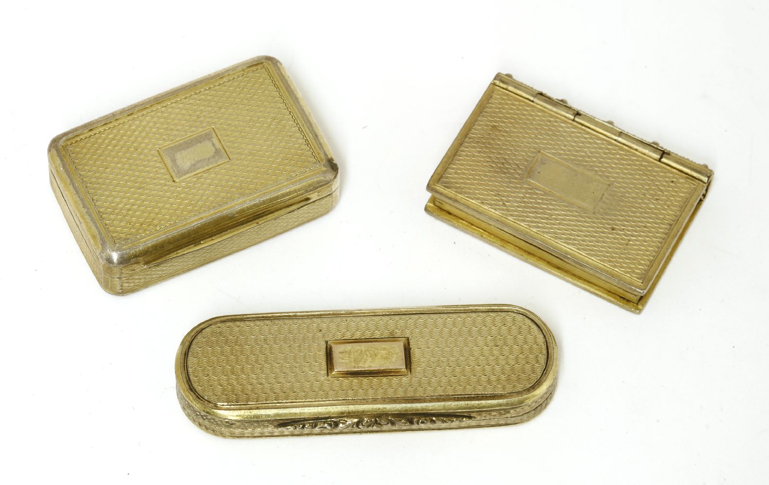 Three silver gilt vinaigrettes,Nathaniel Mills, Birmingham 1835,of 'tooth pick box' shape, with