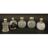 Four cut-glass cologne bottles,with silver covers,London 1888, 1889,1894 and Chester 1896,