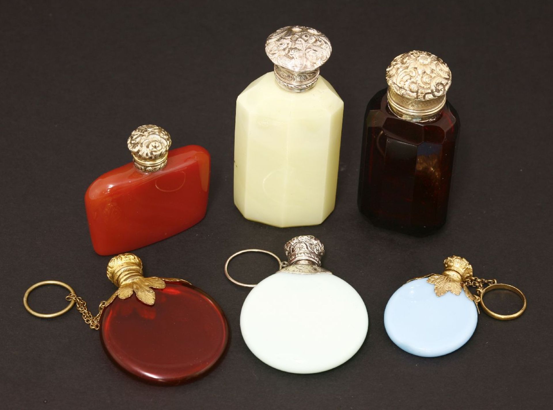 Six scent bottles,19th century, two with opaque blue bodies, one with a white metal cover