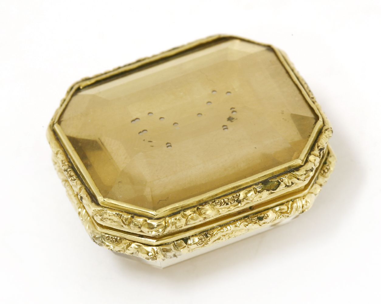 A gold-cased citrine vinaigrette,c.1820, the step-cut citrine within a chased floral border, with