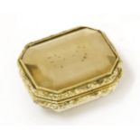 A gold-cased citrine vinaigrette,c.1820, the step-cut citrine within a chased floral border, with