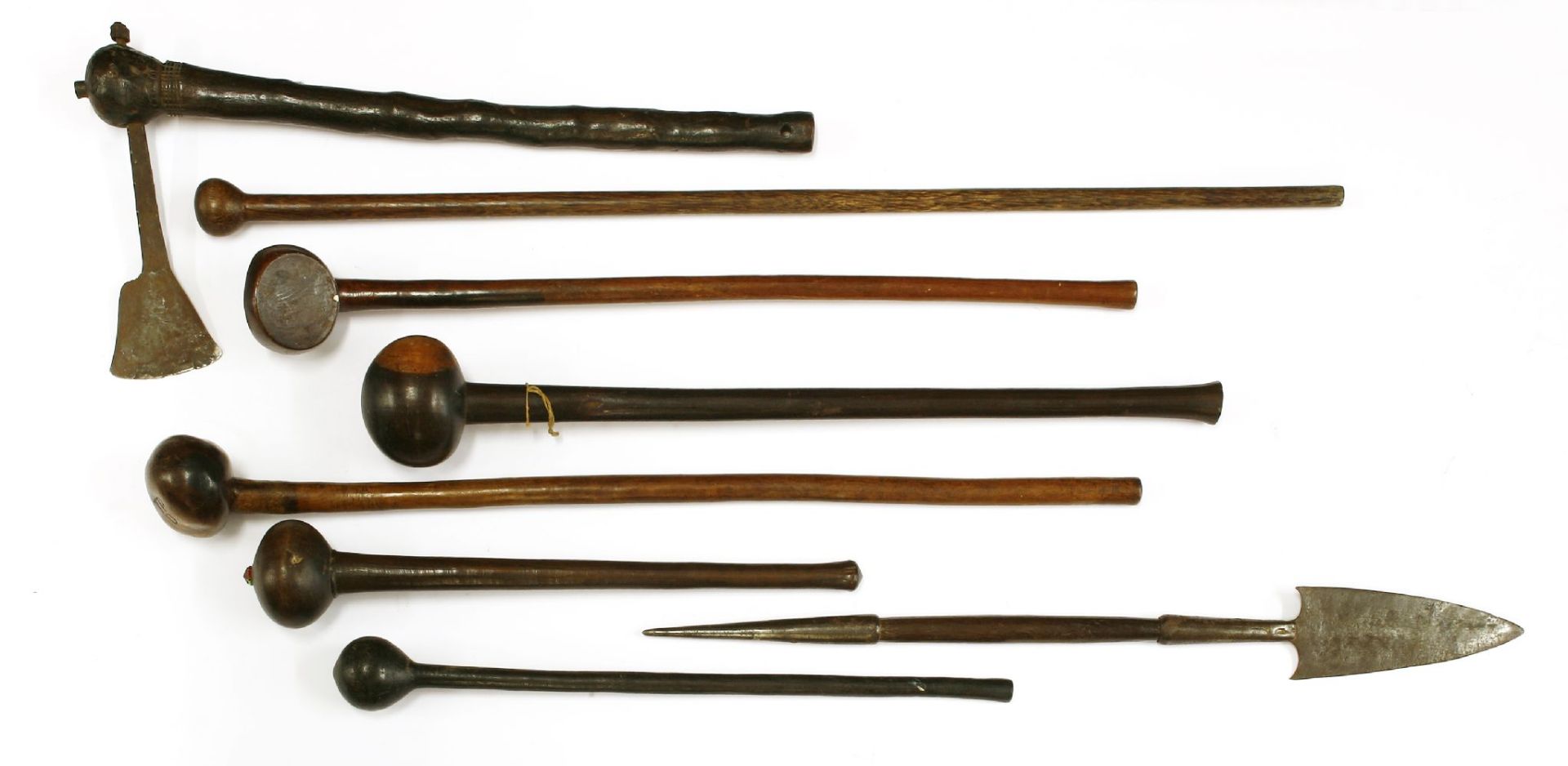 A collection of six knobkerries,longest 88cm,a short spear,69cm long, andan axe,56cm long (8)