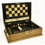 A Victorian walnut games compendium,the brass bound case opening to reveal chess and draughts