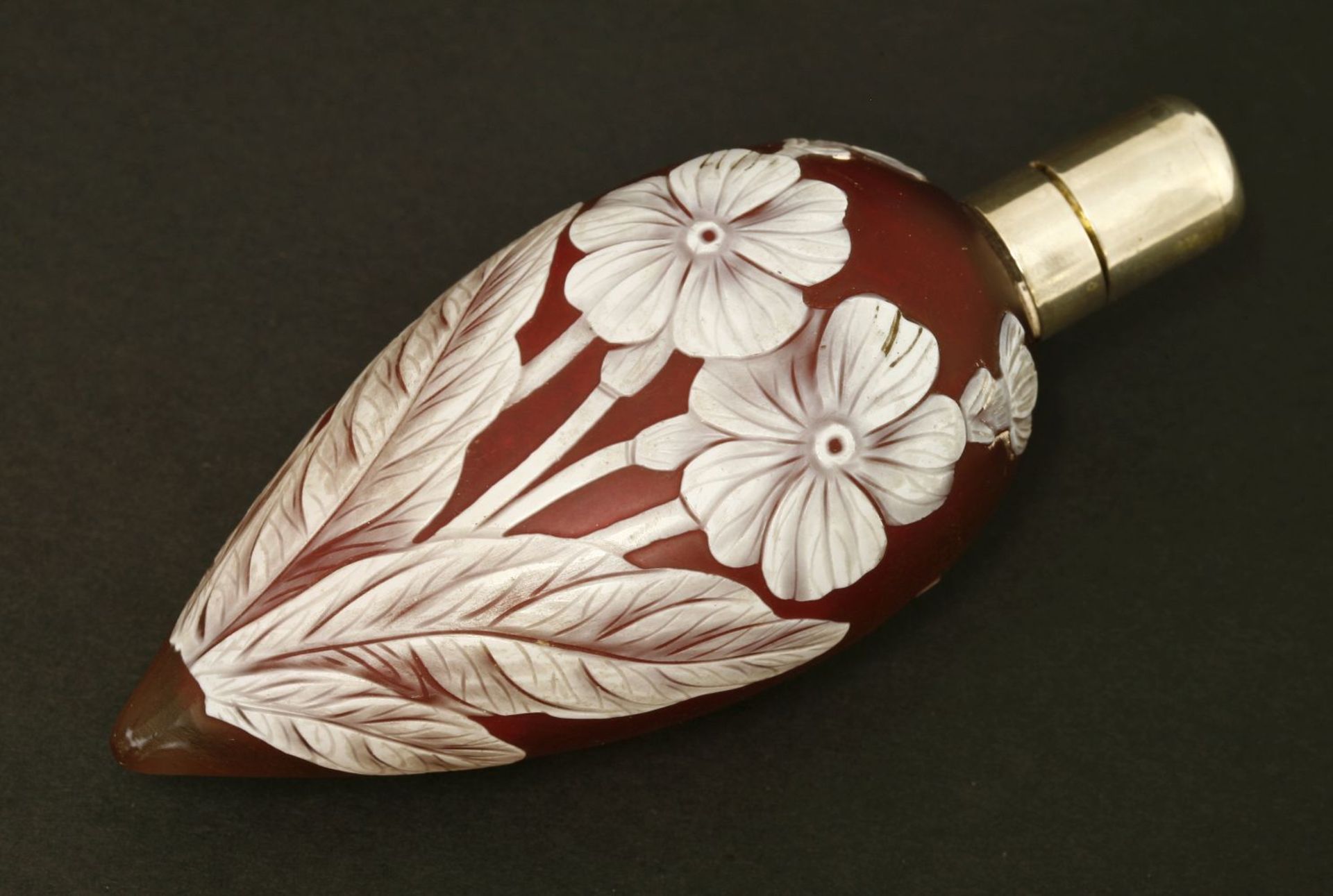 A cameo glass scent bottle,by Thomas Webb & Co, Stourbridge, the ruby glass of teardrop shape