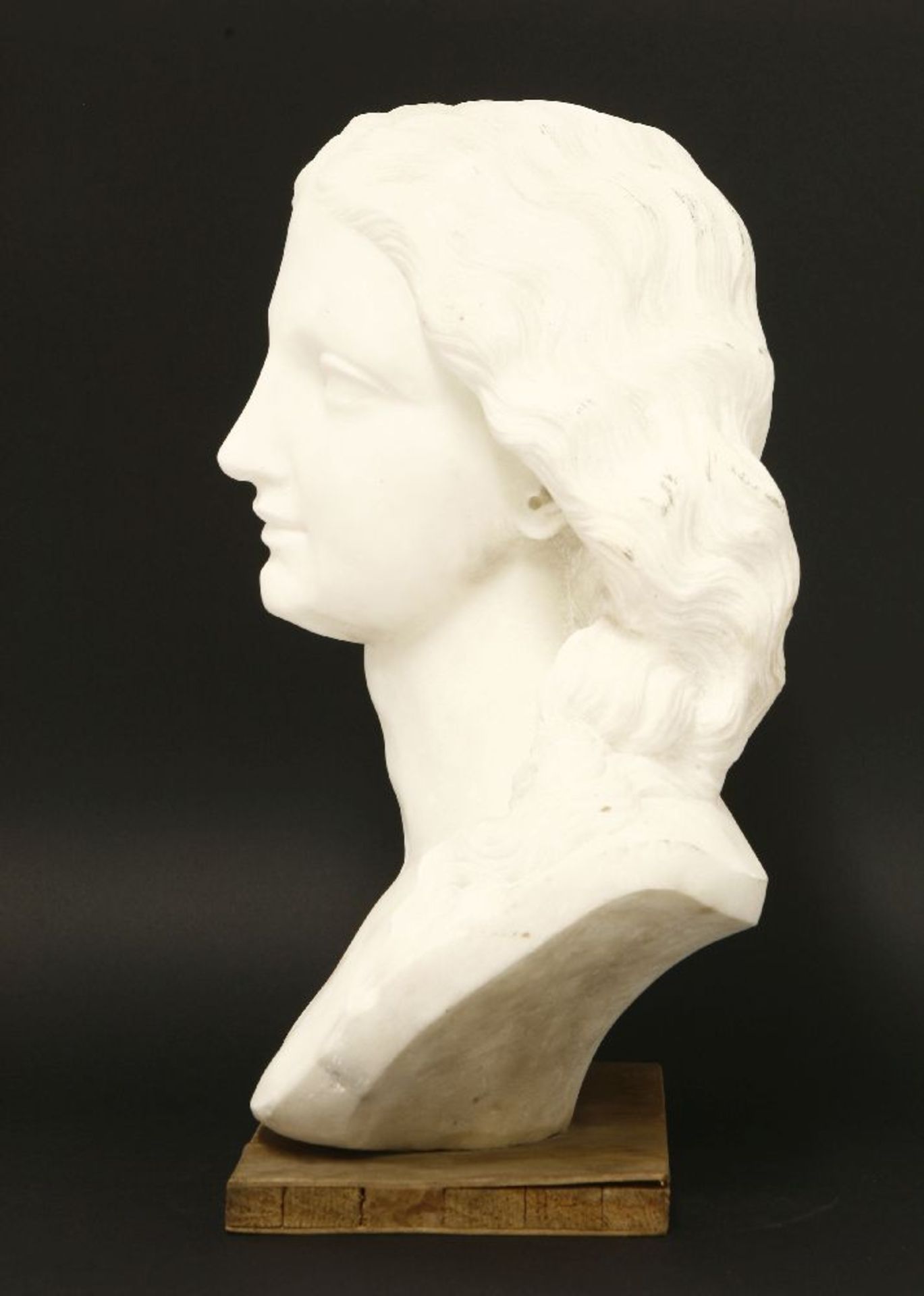 A marble bust,20th century, of a lady with flowing hair, on a plywood plinth,38cm high - Image 2 of 3