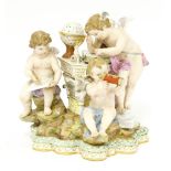 A Meissen porcelain 'Mapping the Stars' group,c.1880, modelled with three putti around a table