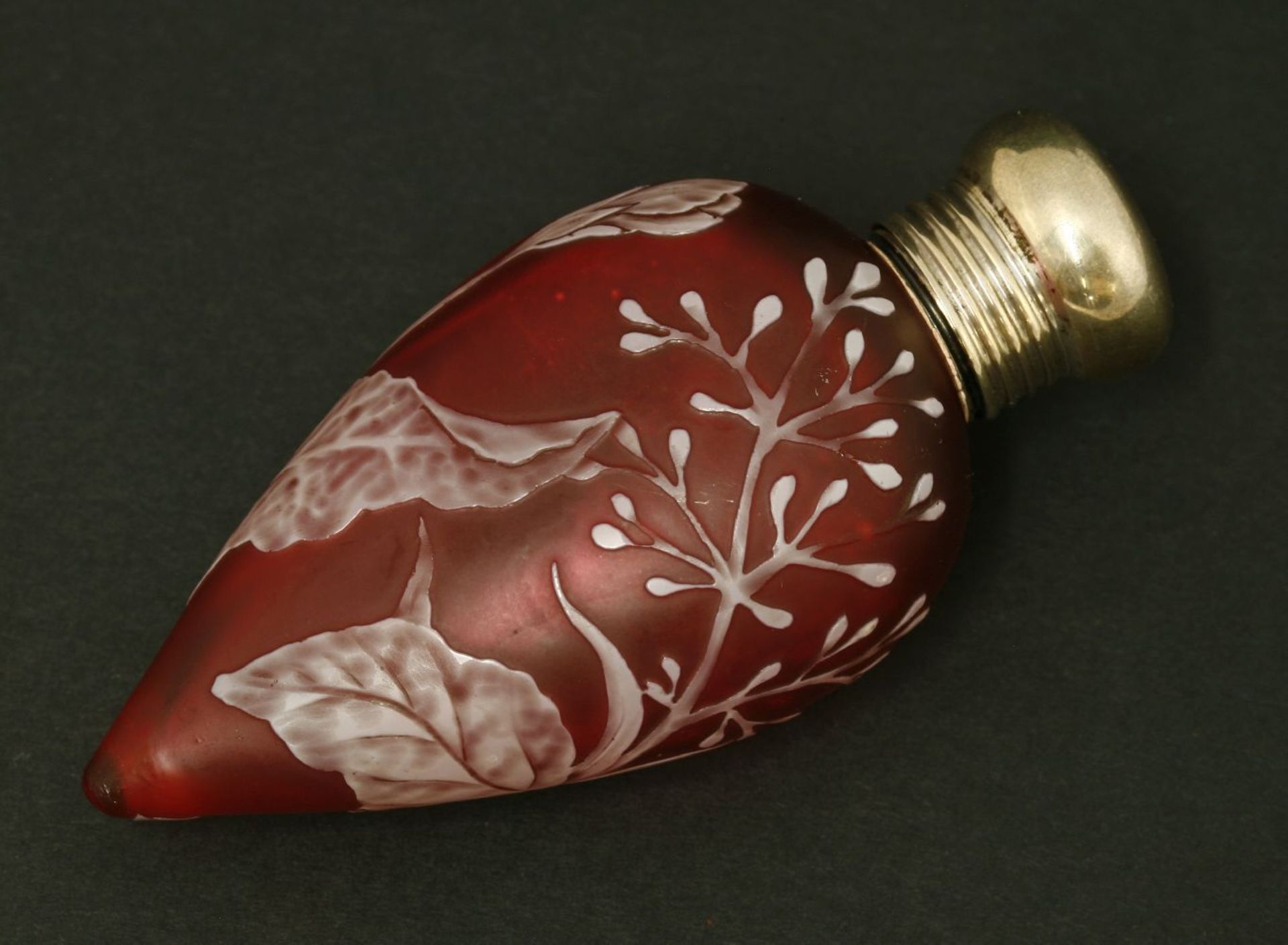 A cameo glass scent bottle, by Thomas Webb & Co, Stourbridge, the ruby glass of teardrop shape