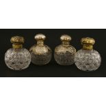 Two pairs of Victorian glass cologne bottles, with silver covers,William Comyns, London 1900,with