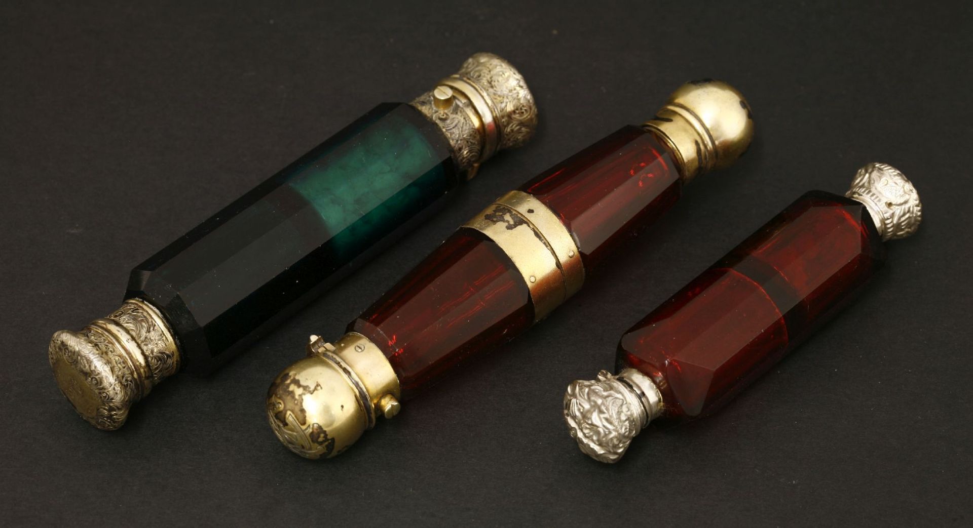 Three Victorian coloured glass double-ended scent bottles,one ruby glass with a central