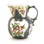 A Worcester jug, c.1765, the leaf-moulded body with a blue-scaled ground with panels of exotic