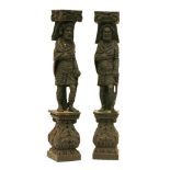 A pair of carved oak furniture mounts,19th century, worked as soldiers on square acanthus bases,52cm