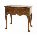 A walnut and inlaid lowboy, early 18th century, the moulded rectangular top with inlaid border