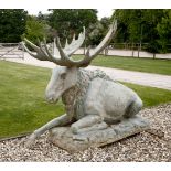 A patinated metal figure of a seated moose,174cm long132cm high