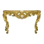 A French giltwood console table,18th century, the shaped front and scrolling legs with open carved