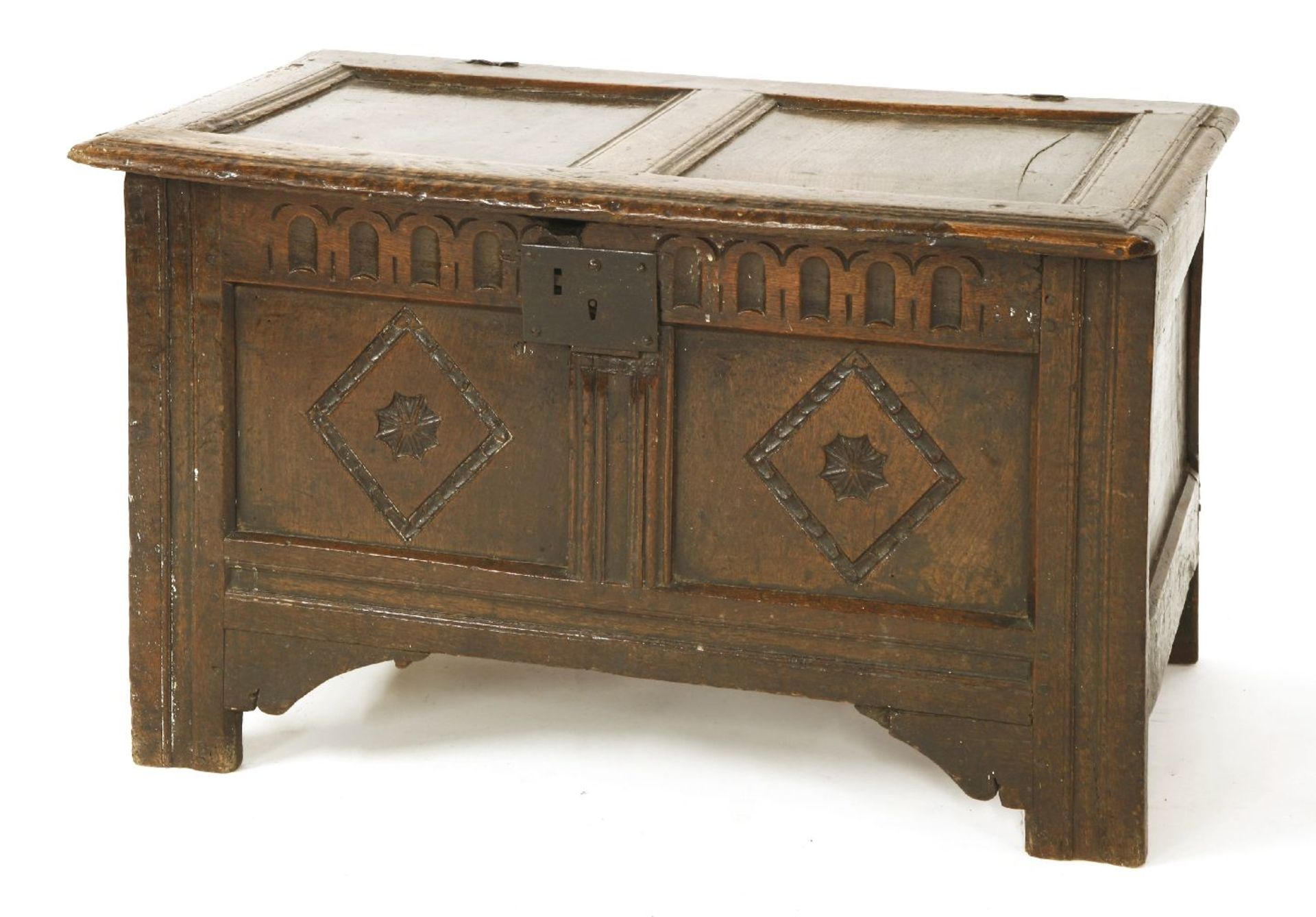 A small oak coffer, 17th century, with a twin panel lid and carved front,90cm wide51cm deep55cm