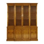 A large Victorian oak breakfront bookcase, the glazed upper section with doors opening to reveal