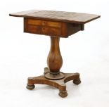 A yew wood and burr maple games table, with a chequer top and drop leaves over two frieze drawers,