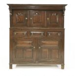 An oak court cupboard,17th century, the top section with three panelled doors, the base with three