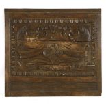 A carved oak panel, 17th century and later, possibly from a ship, mounted, centred with a mask