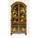 A large japanned corner cupboard,18th century, the domed top over twin arching panel doors decorated