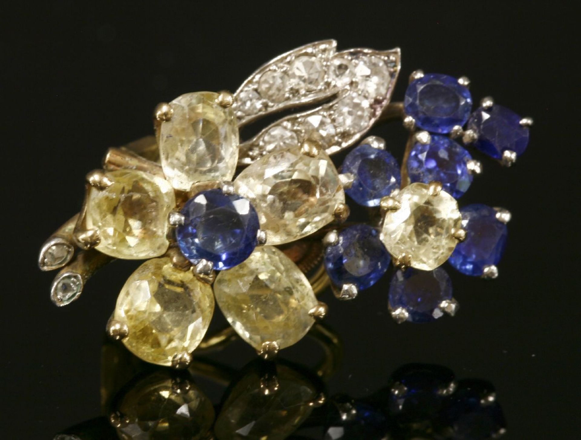 A sapphire and diamond single spray earring,with flower head composed of clusters of blue and yellow