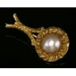 A William IV Halley's comet brooch, c.1836,with a split pearl, claw set to a chased border and comet