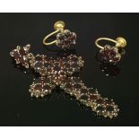 A Victorian bohemian garnet cross,with clusters of graduated circular garnets forming the Latin-