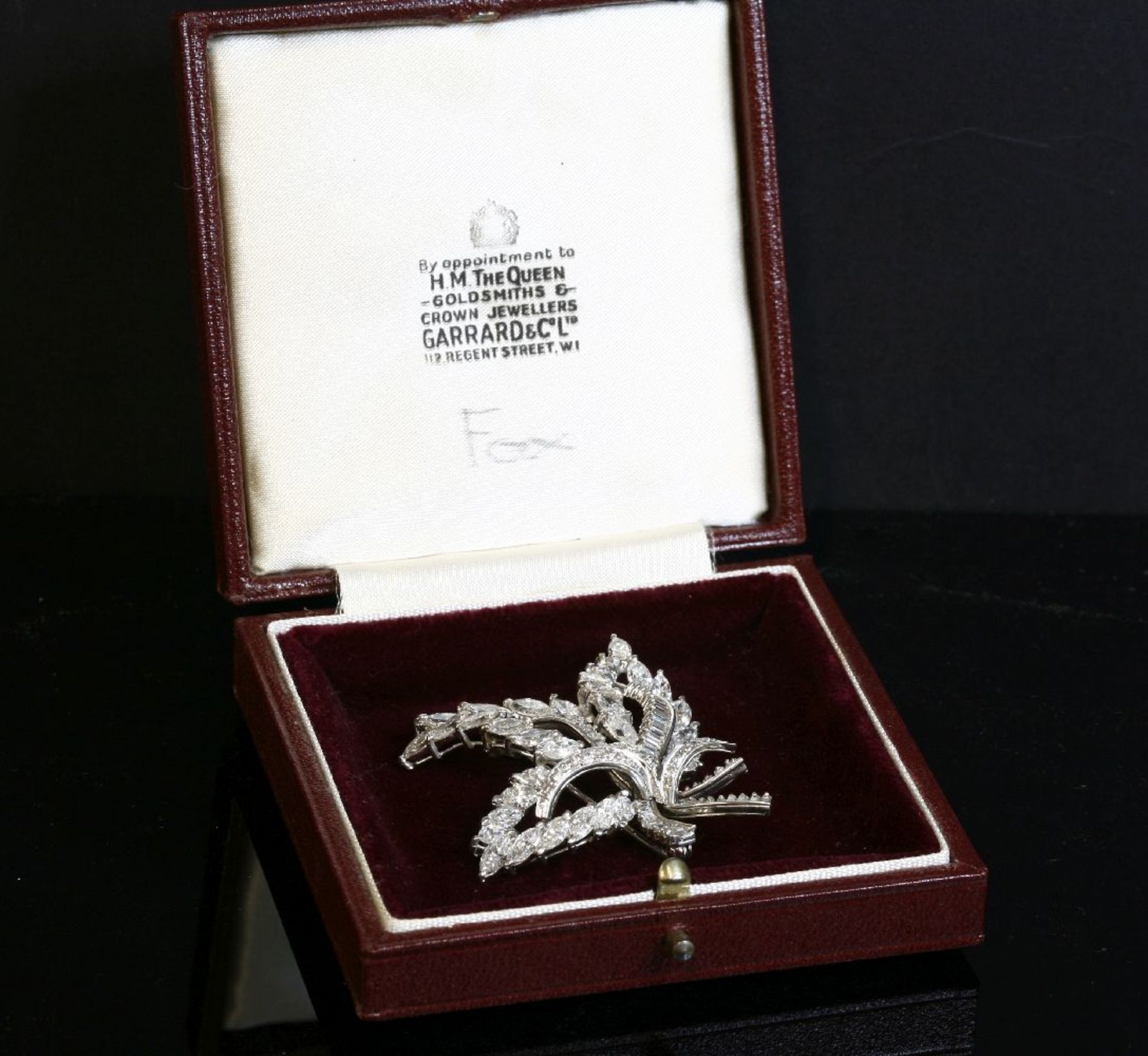 A platinum and diamond set leaf spray brooch, c.1950, with a series of open leaf shapes composed - Image 2 of 2