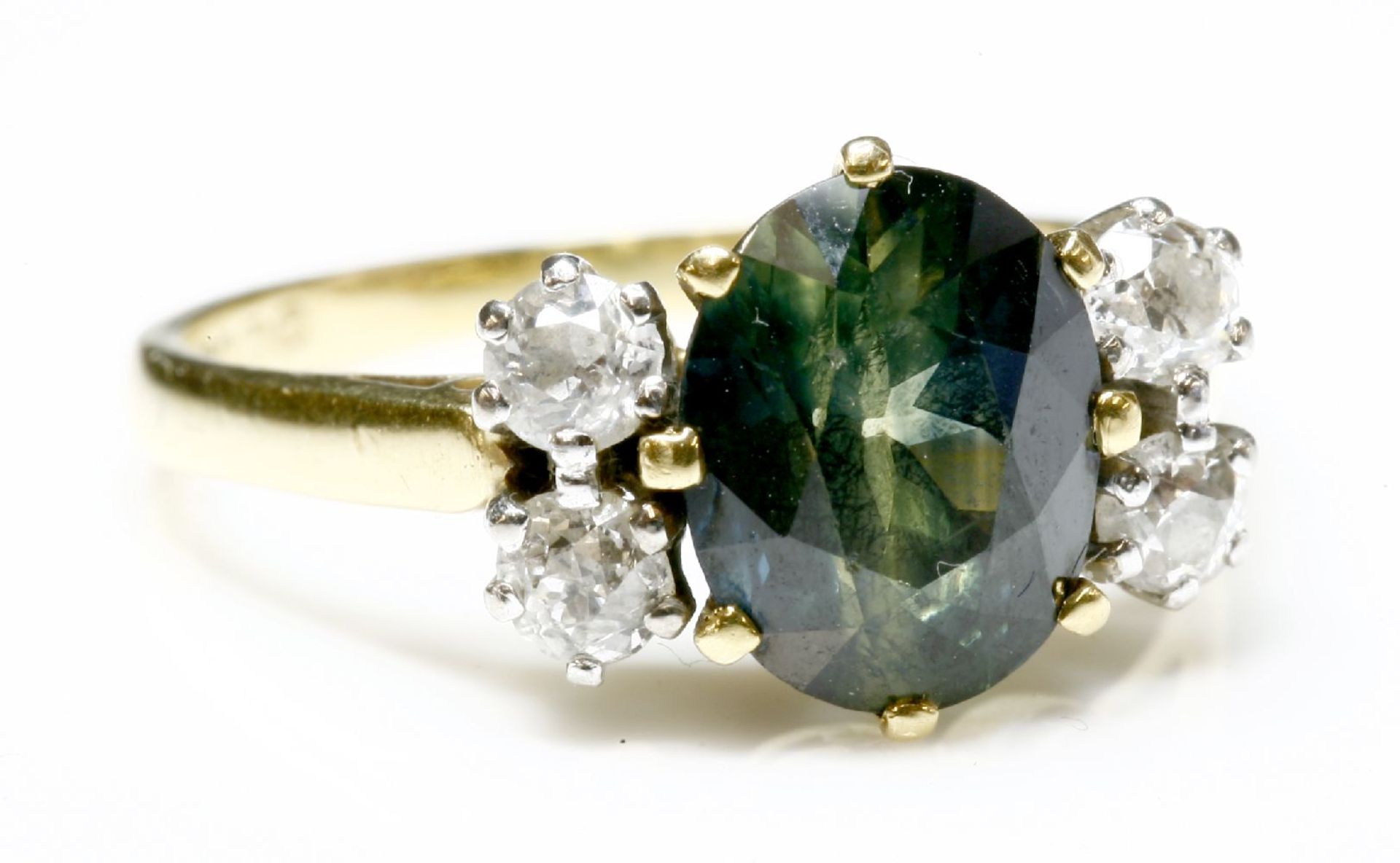 A green sapphire and diamond ring,with an oval mixed cut sapphire, claw set to the centre in a - Image 2 of 2