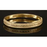 A 15ct gold Victorian Etruscan-style hinged bangle,with applied twisted wires and beads to the top