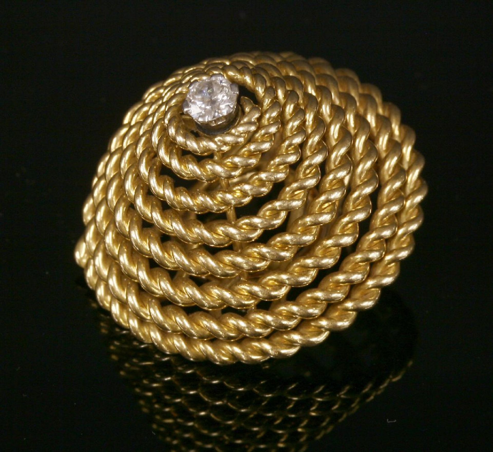 A French gold single diamond earring,by Marchak Paris, of conical form, composed of coiled twisted