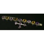 A late Victorian silver amethyst and citrine bracelet, with a series of oval mixed cut amethysts and