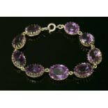 A Victorian graduated amethyst bracelet,with a series of oval mixed cut amethysts, all claw set in