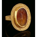 A high carat gold cornelian intaglio ring,possibly Roman, 3rd or 4th century. A flat oval