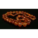 A single row graduated amber bead necklace,with circular and bouton-shaped faceted amber beads, 8.